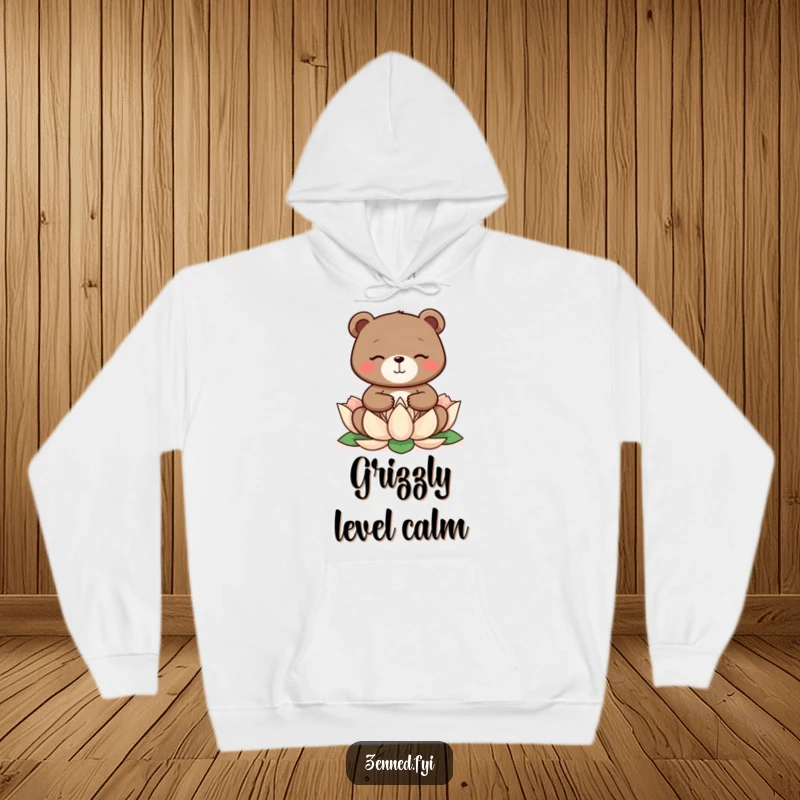 A happy bear meditates on a lotus flower, featured on a warm hoodie, an excellent funny gift.
